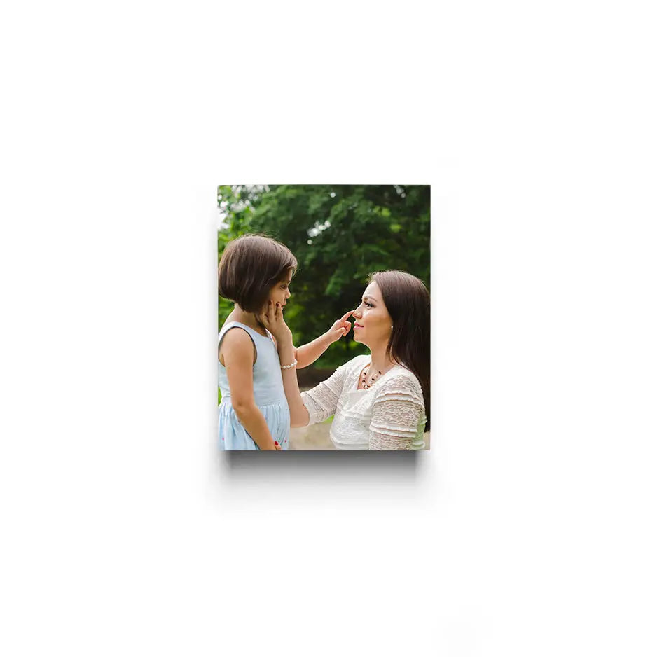 Woman applying makeup to daughter’s face with a brush for a 8x10 cove photo