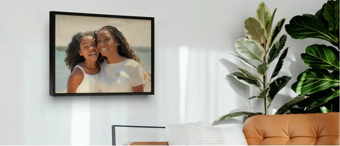 Framed photograph of two smiling people with curly hair celebrating cherished memories.