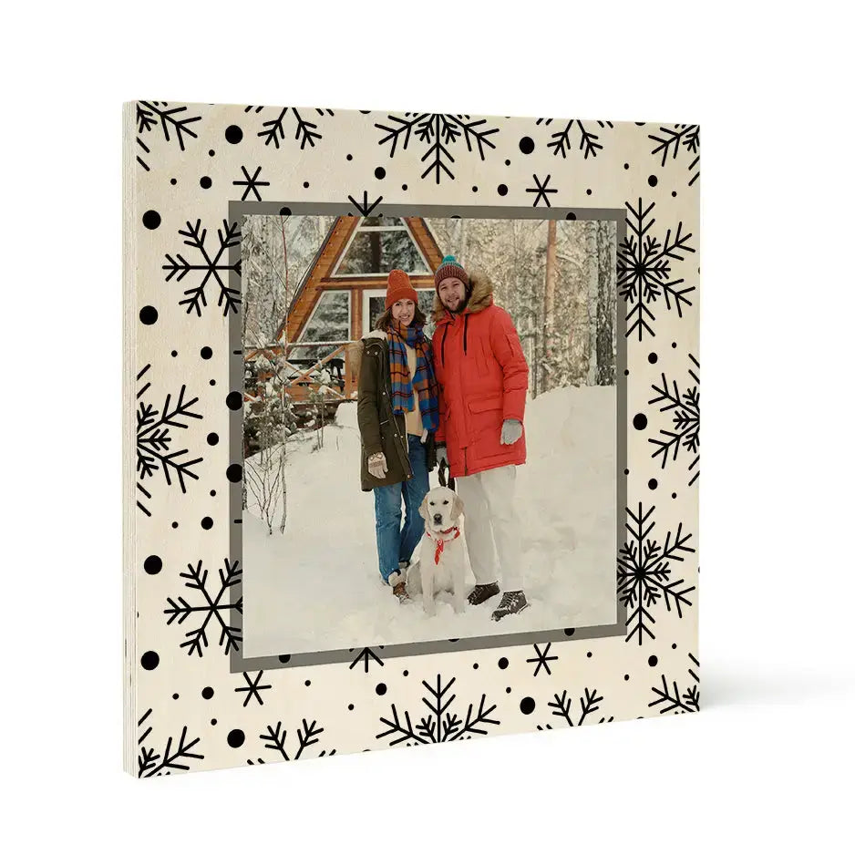 Framed winter photograph of people by a cabin, ideal for Woodsnap’s birch pattern wood prints.