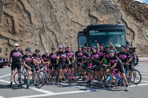 Group of cyclists in black and pink uniforms supporting Pablove Foundation’s Crafting Kindness.