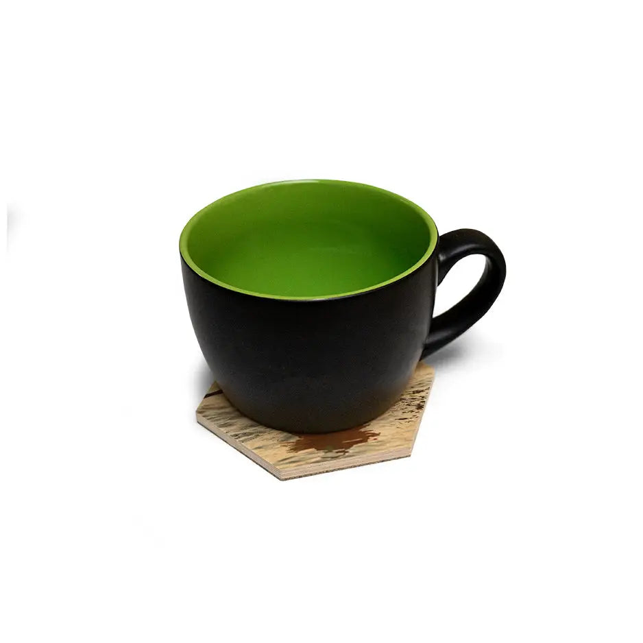 Green cup on a wooden coaster from the Hexagon Coaster Set showcasing wood print vintage design