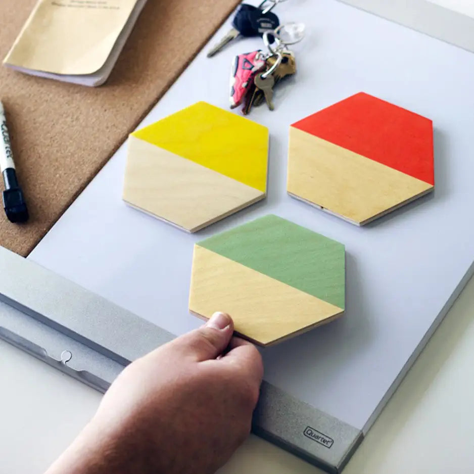 Person crafting a geometric puzzle with Hexagon Wood Print Magnet Set