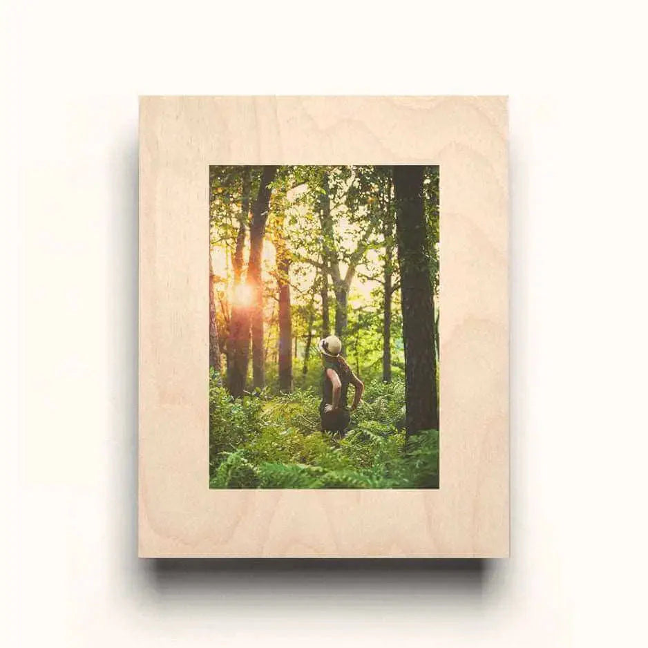 Framed photograph of a person in sunlit forest on Natural Wood Mat Rectangle Wood Print