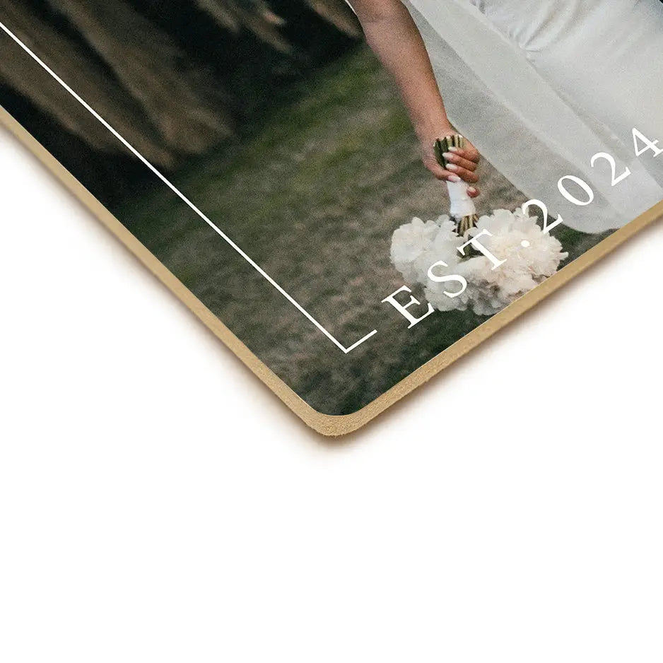 Bride holding bouquet beside Love Est. Wood Plaque and vintage wood print decor