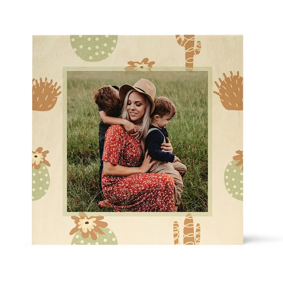 Framed photograph of a woman with children in a grassy field on Pattern Wood Print