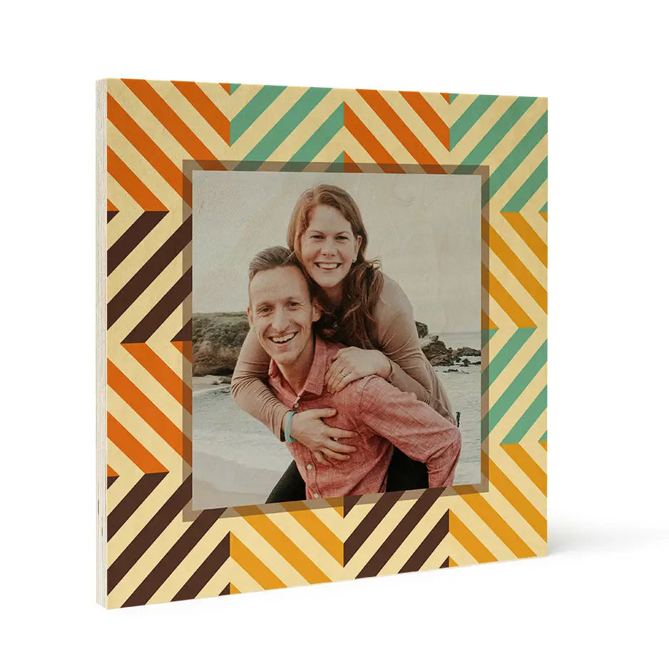 Framed photograph of a smiling couple in a colorful pattern wood print design