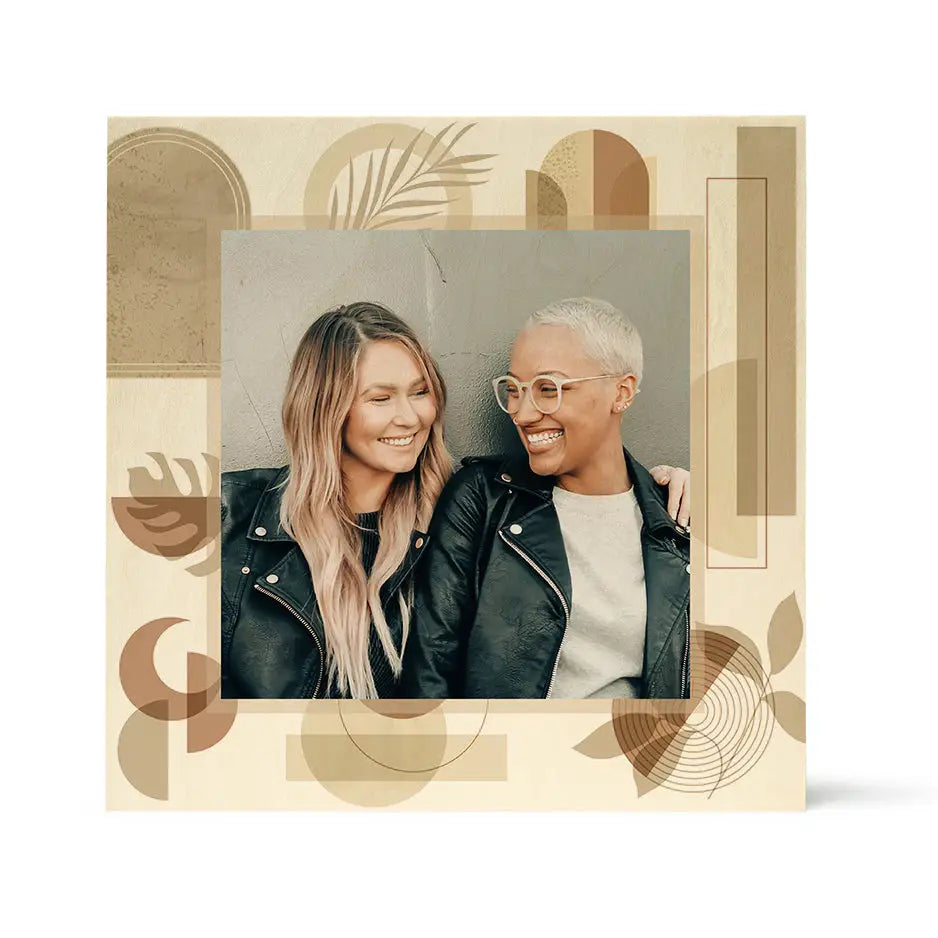 Two smiling people in black leather jackets with Pattern Wood Print - Earth & Moon backdrop