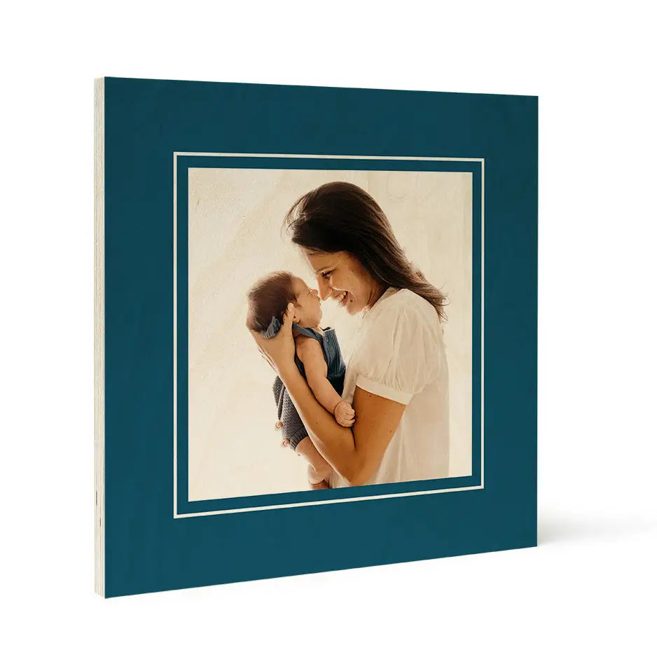 Framed photograph of a woman holding a baby on Matte Wood Print in Matte Cactus Green