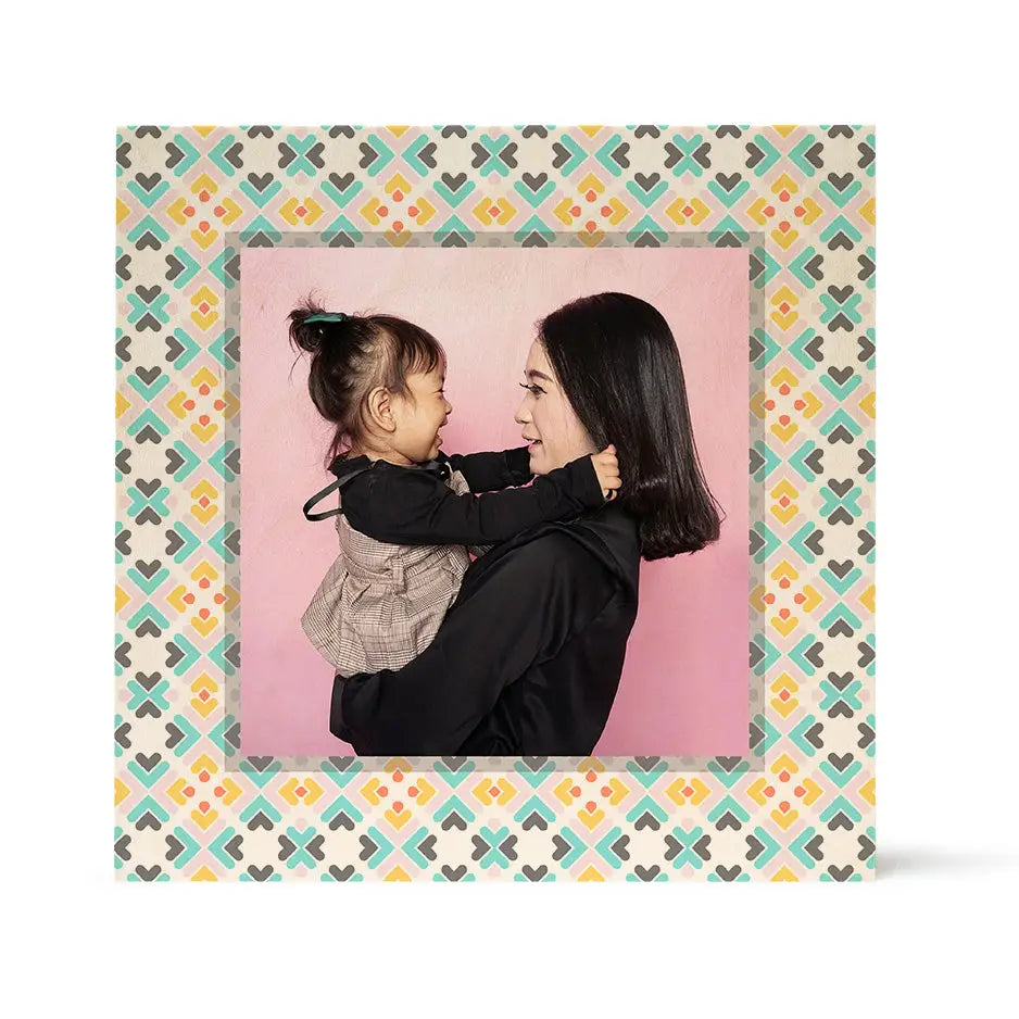 Framed photograph of a woman and child on Pattern Wood Print with pink background