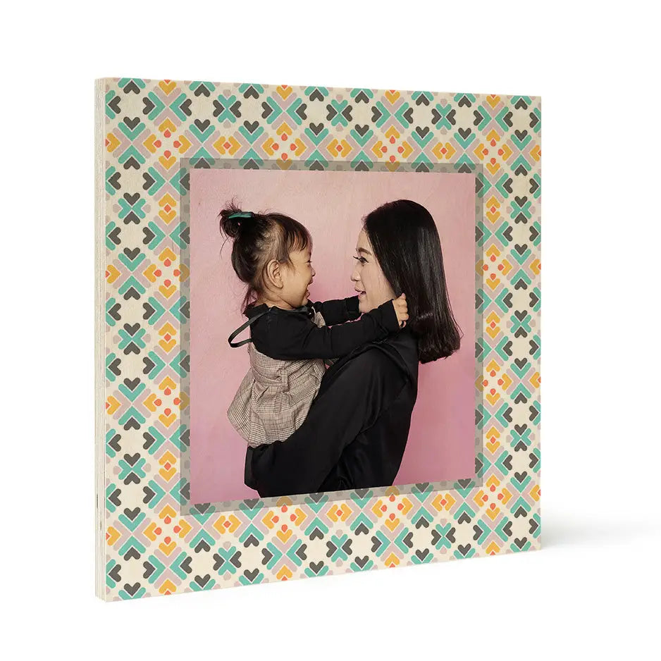 Framed photograph of a woman and child on a Pattern Wood Print against pink background