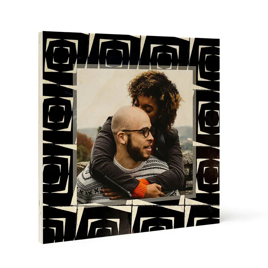 Couple embracing outdoors in a Pattern Wood Print featuring an Abstract Tile design