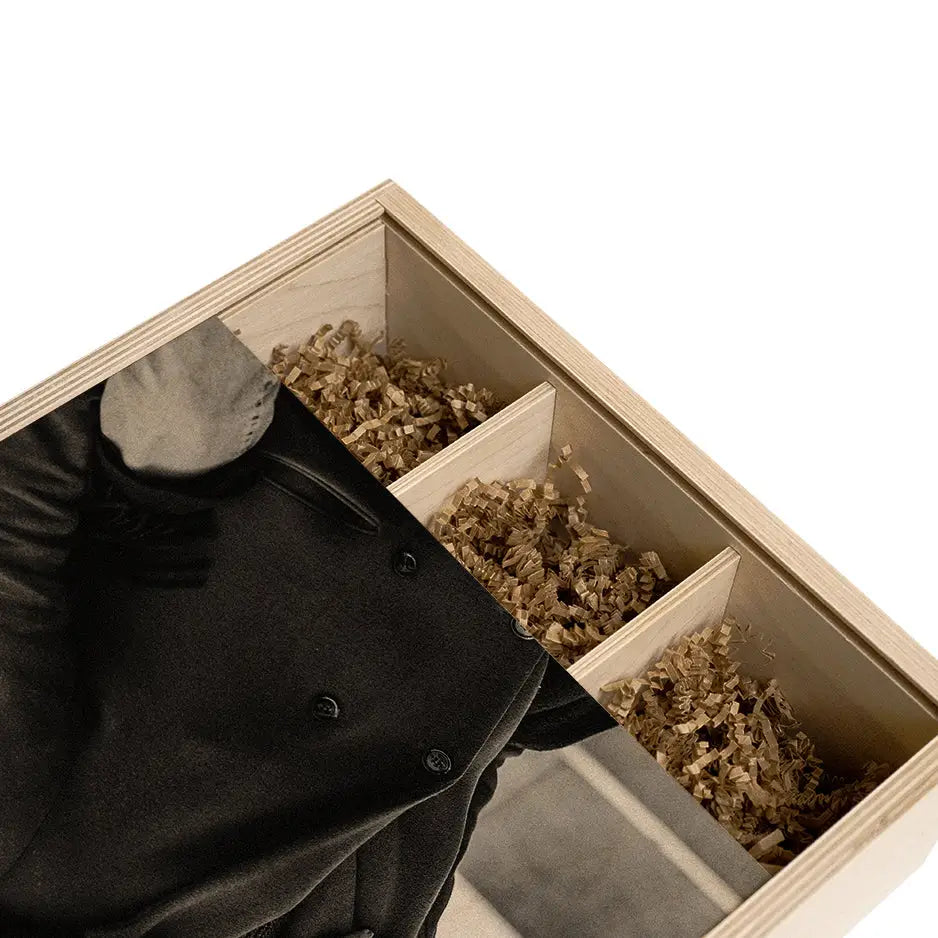 Man in a black jacket holding a box of dried flowers in a Personalized Triple Bottle Wood Box