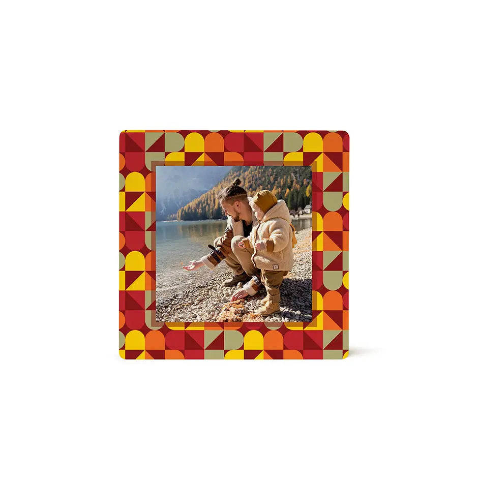 Framed photo tile of two people on a rocky beach with fall geometrics design