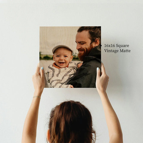 Man holding a smiling baby, showcasing the warmth of photo printing on wood prints.