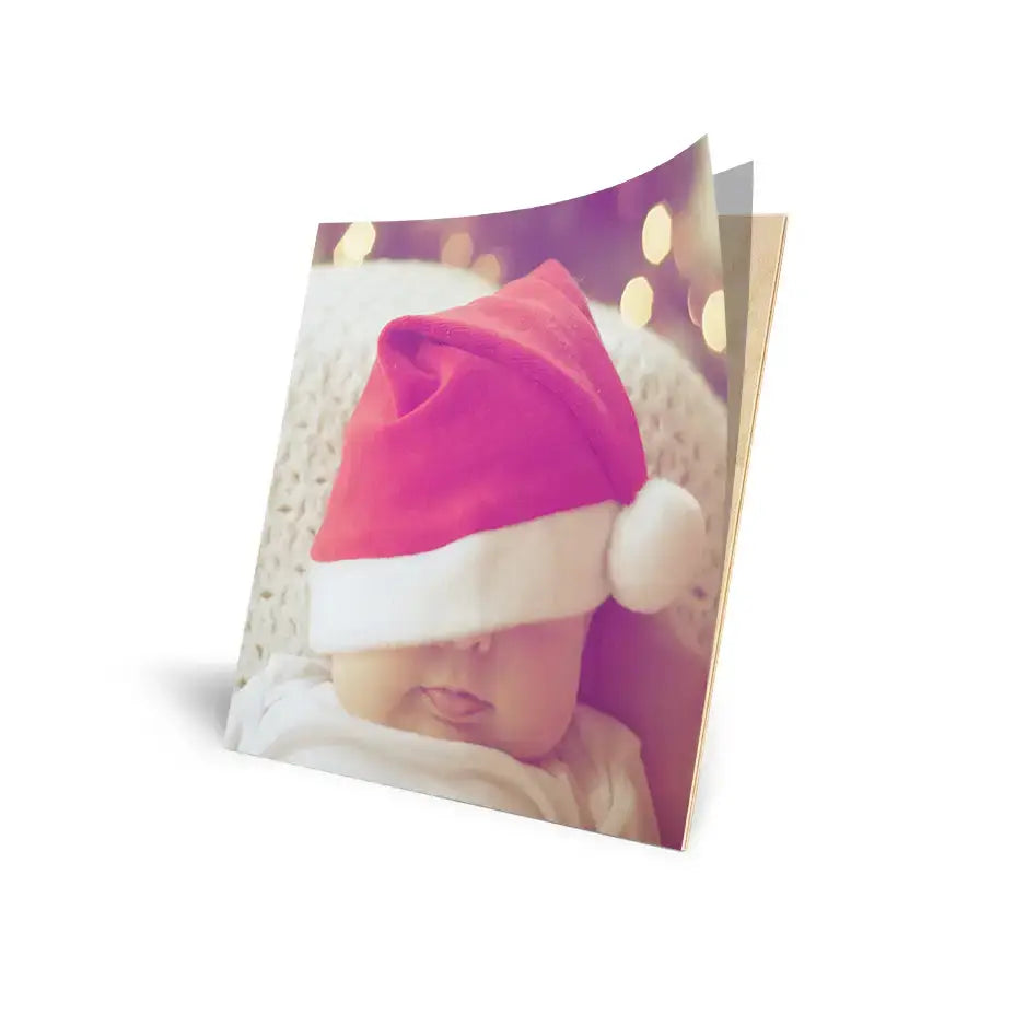 Red and white Santa hat partially covering a cove photo mount in a festive setting.