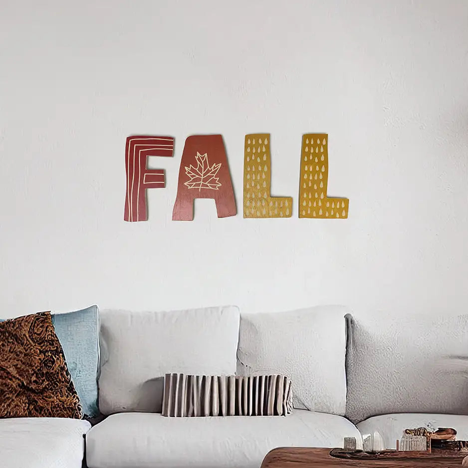 Decorative wall art with colorful textured letters spelling FALL in autumn decor style