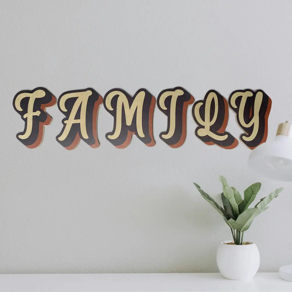 Decorative wall text spelling out ’FAMILY’ in stylized 3D letters with shadowing.