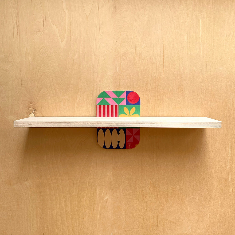 Colorful geometric supports on a simple and sturdy wall shelf for natural warmth