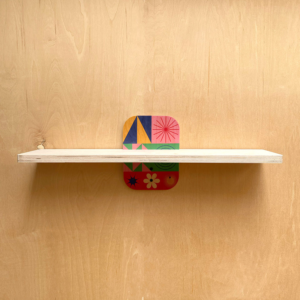 White shelf with colorful geometric supports from Simple and Sturdy Wall Shelves Natural Warmth