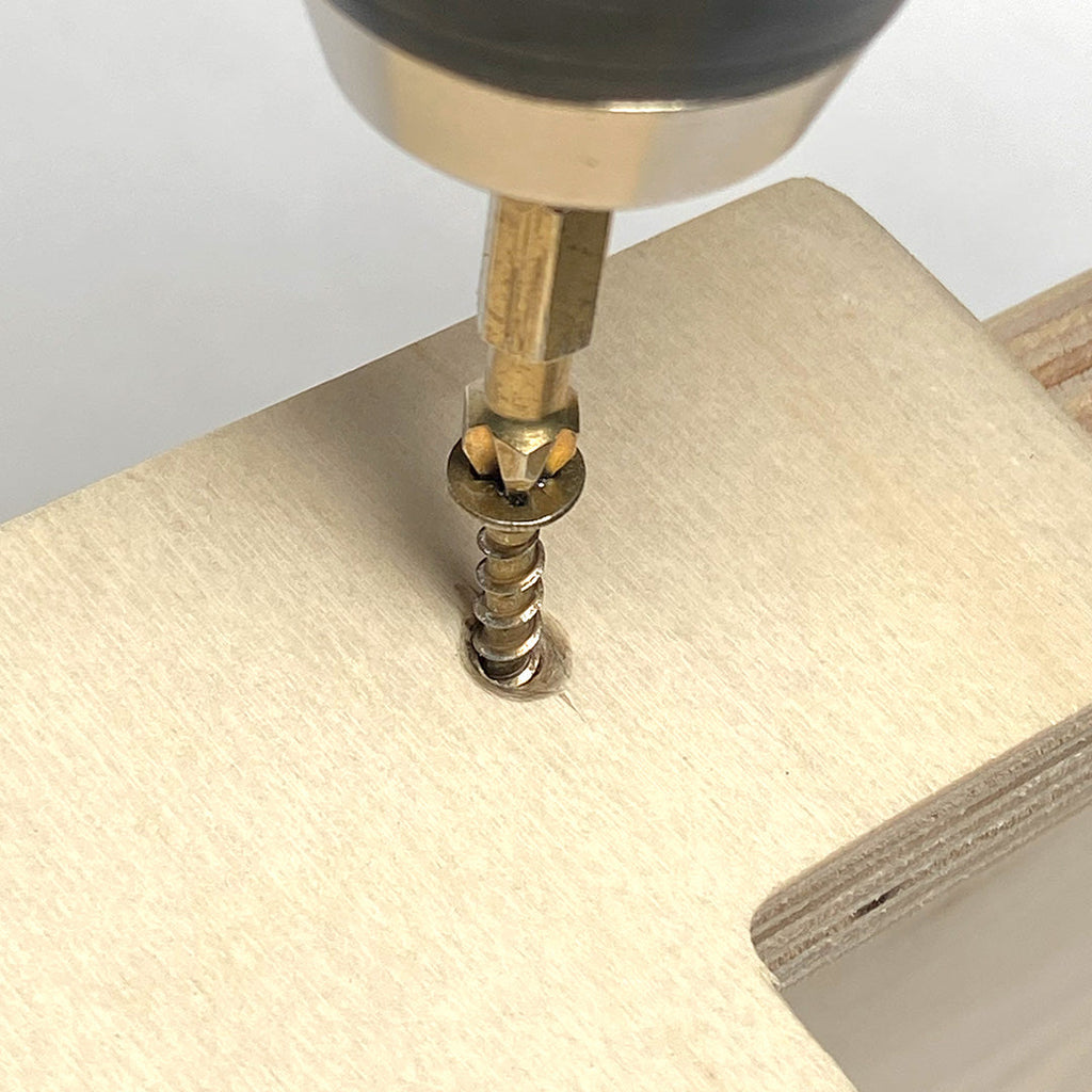 Drill driving screw into wood for sturdy wall shelf installation on a simple and sturdy wall shelf