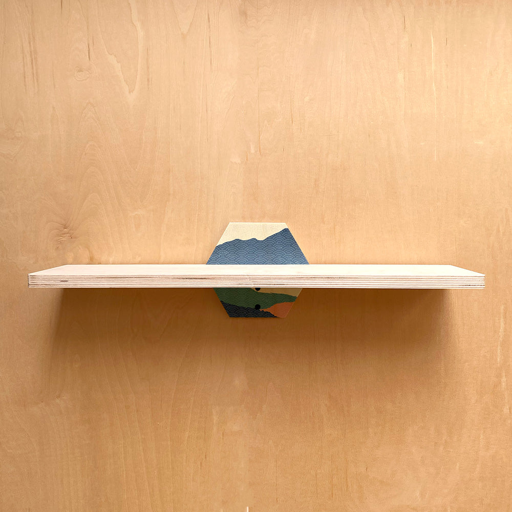 Wooden shelf with hexagonal mountain-themed support, a simple and sturdy wall shelf