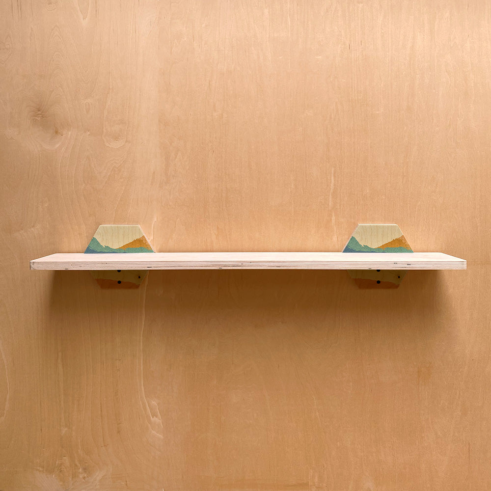 White sturdy wall shelf with mountain-themed supports for a stylish room decor