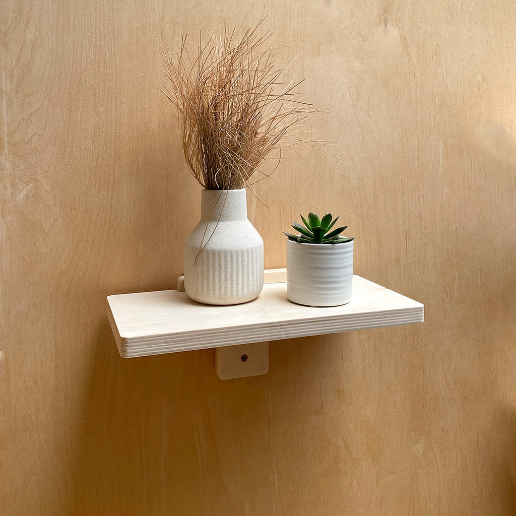Minimalist WoodArc Wall Shelf with decorative items showcasing wood wall shelf design