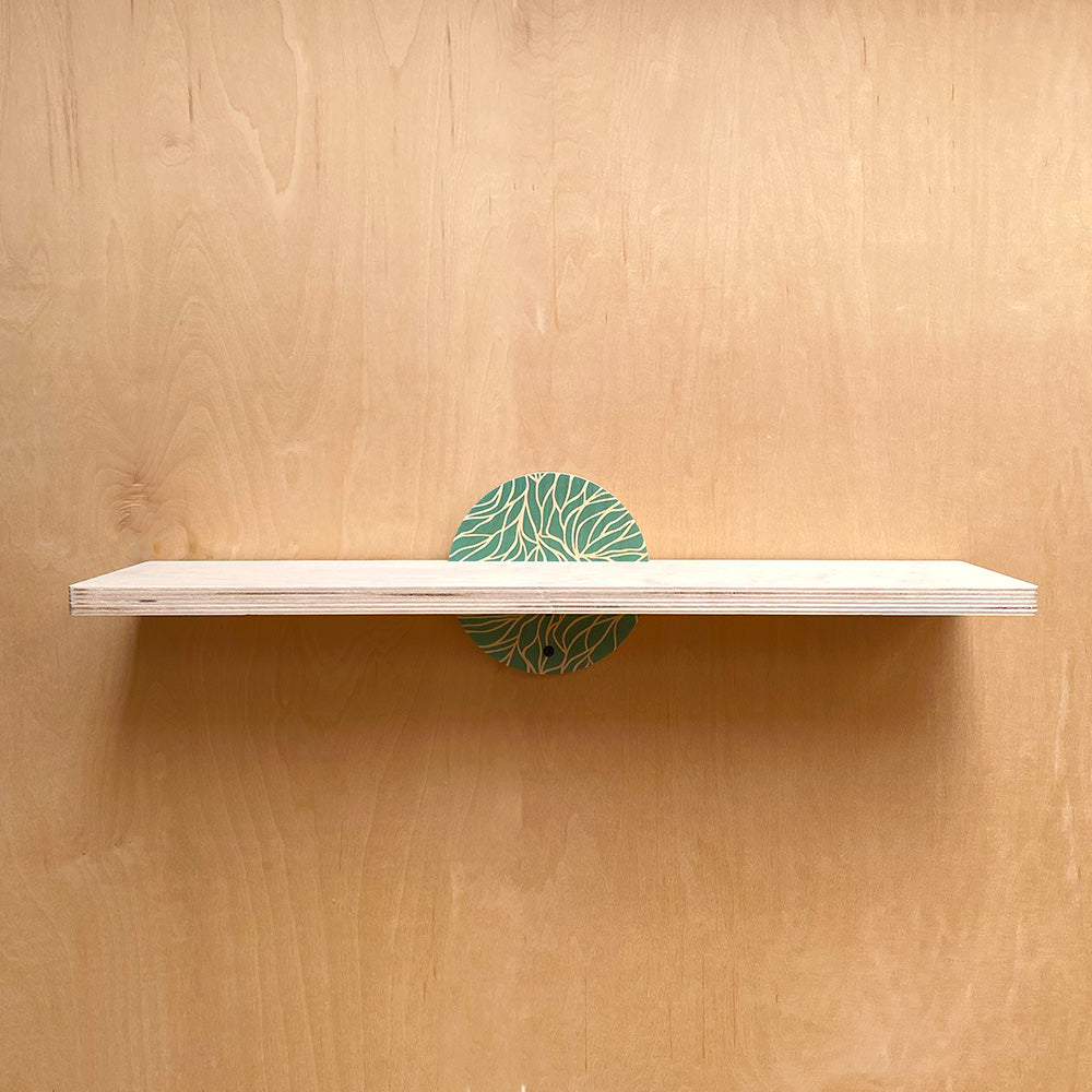 Wooden wall shelf with green circular brackets for a sturdy wall support