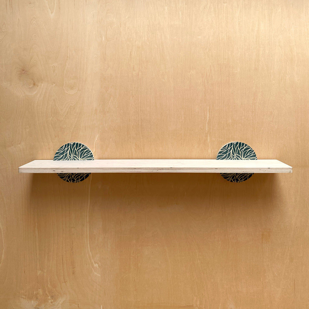 White wall shelf with patterned circular brackets for a sturdy wall storage solution