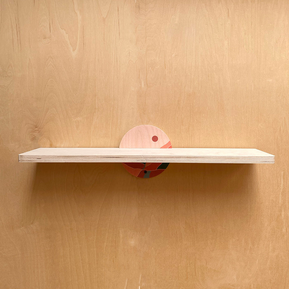 Sturdy wall shelf with decorative circular support for stylish storage and display
