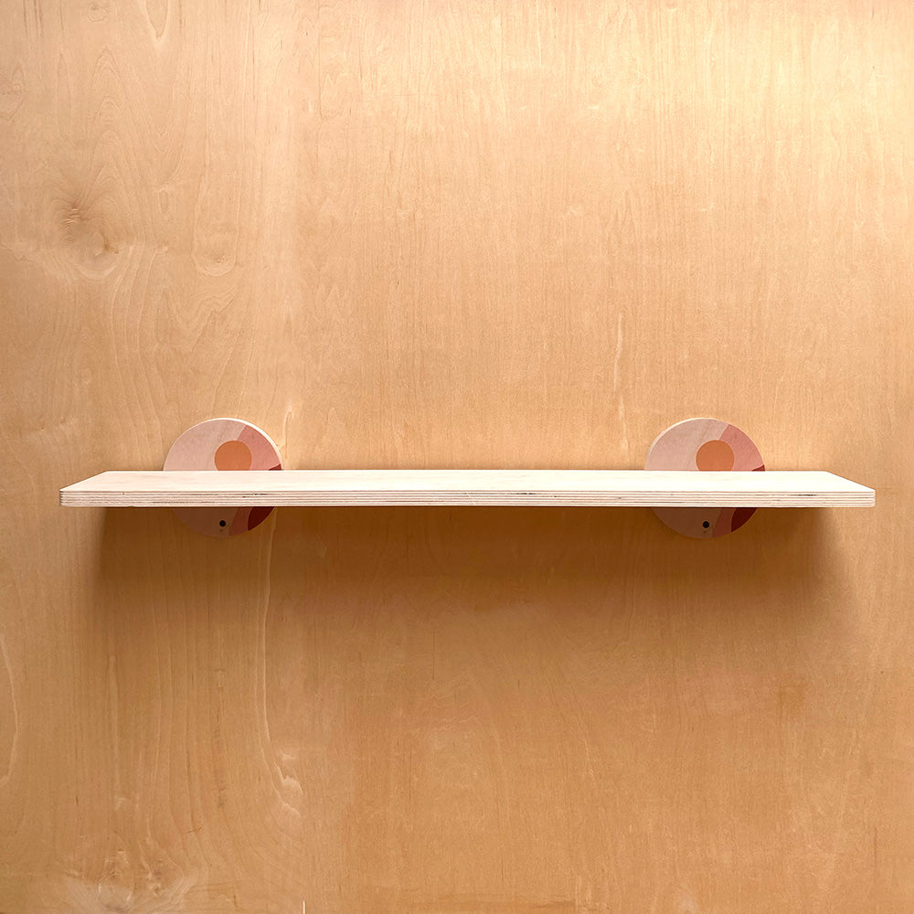 Sturdy wall shelf with circular supports, perfect for artistic home decor