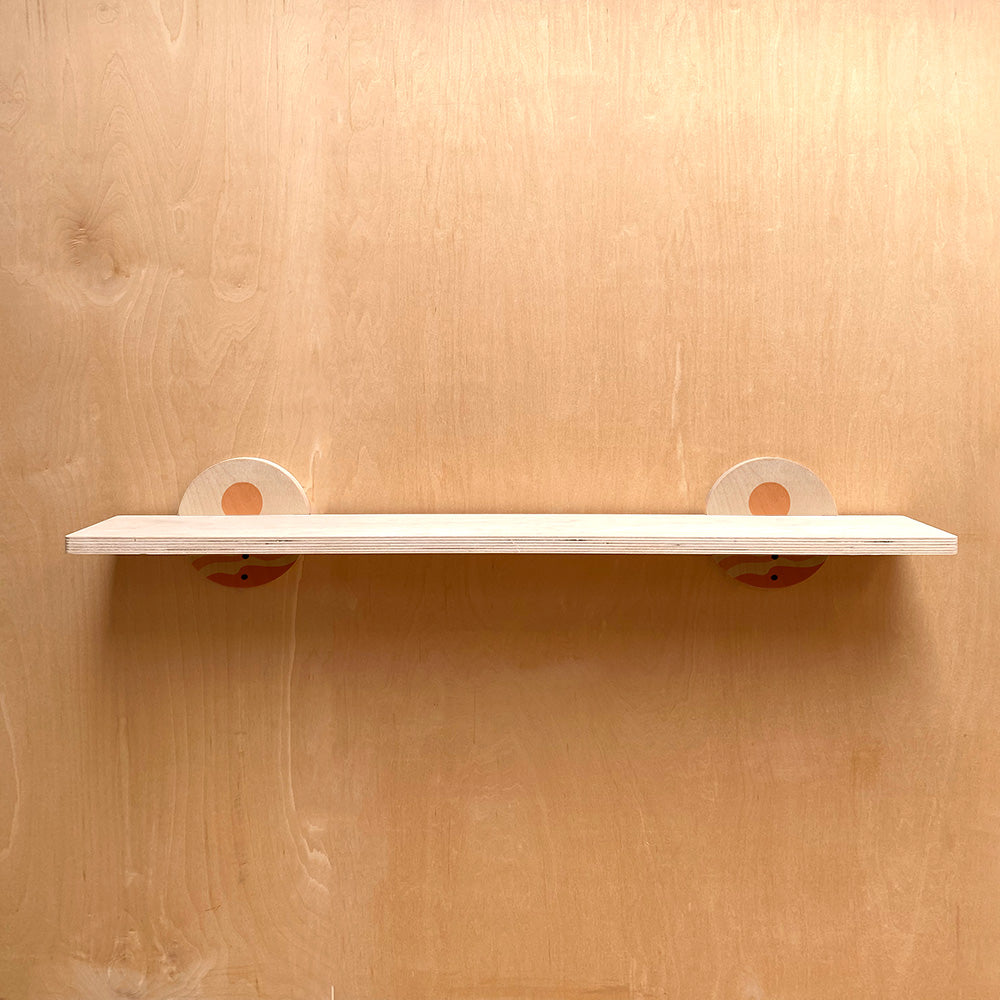 White sturdy wall shelf with circular supports, ideal for artistic home decor