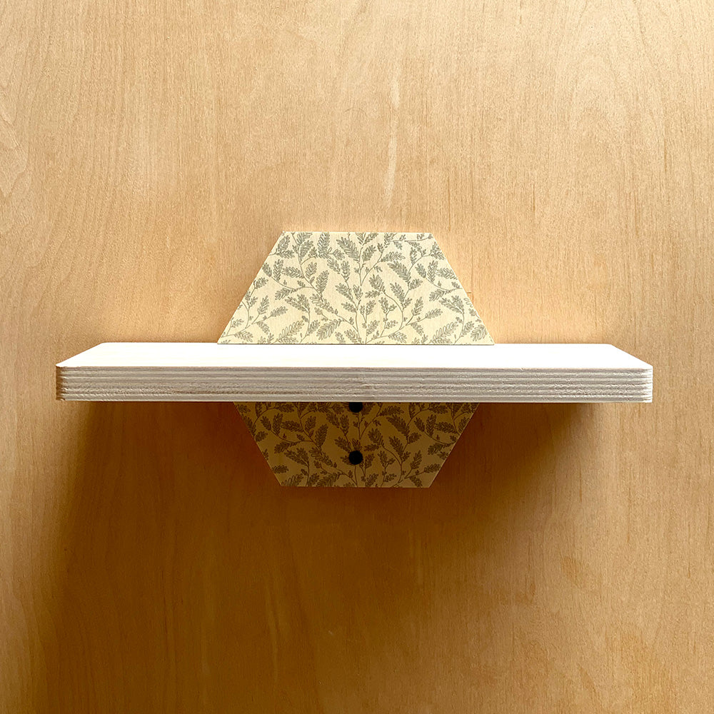 Hexagonal sturdy wall shelf with patterned supports adding natural charm to your space