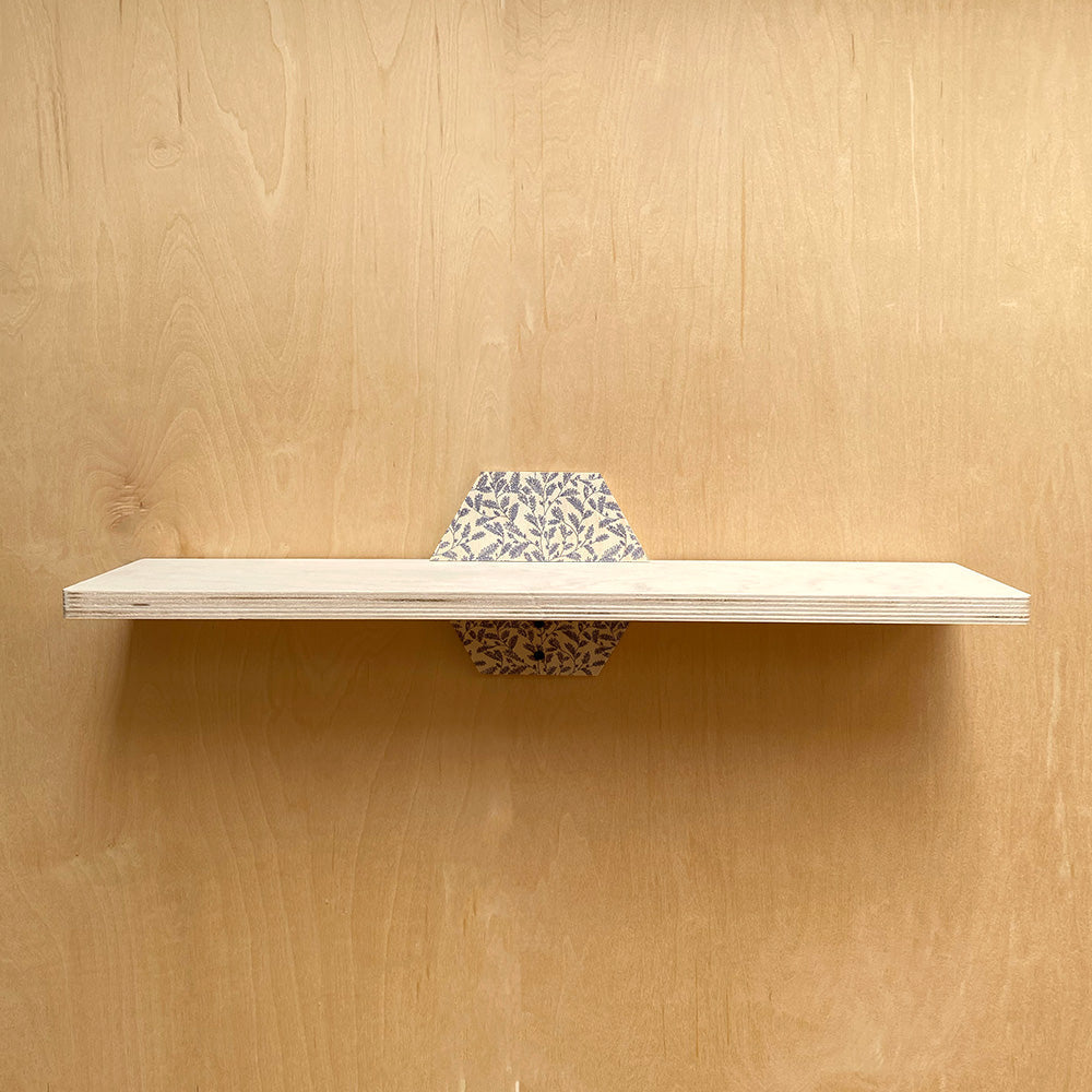 Floating wall shelf with patterned supports, a stylish sturdy wall shelf choice