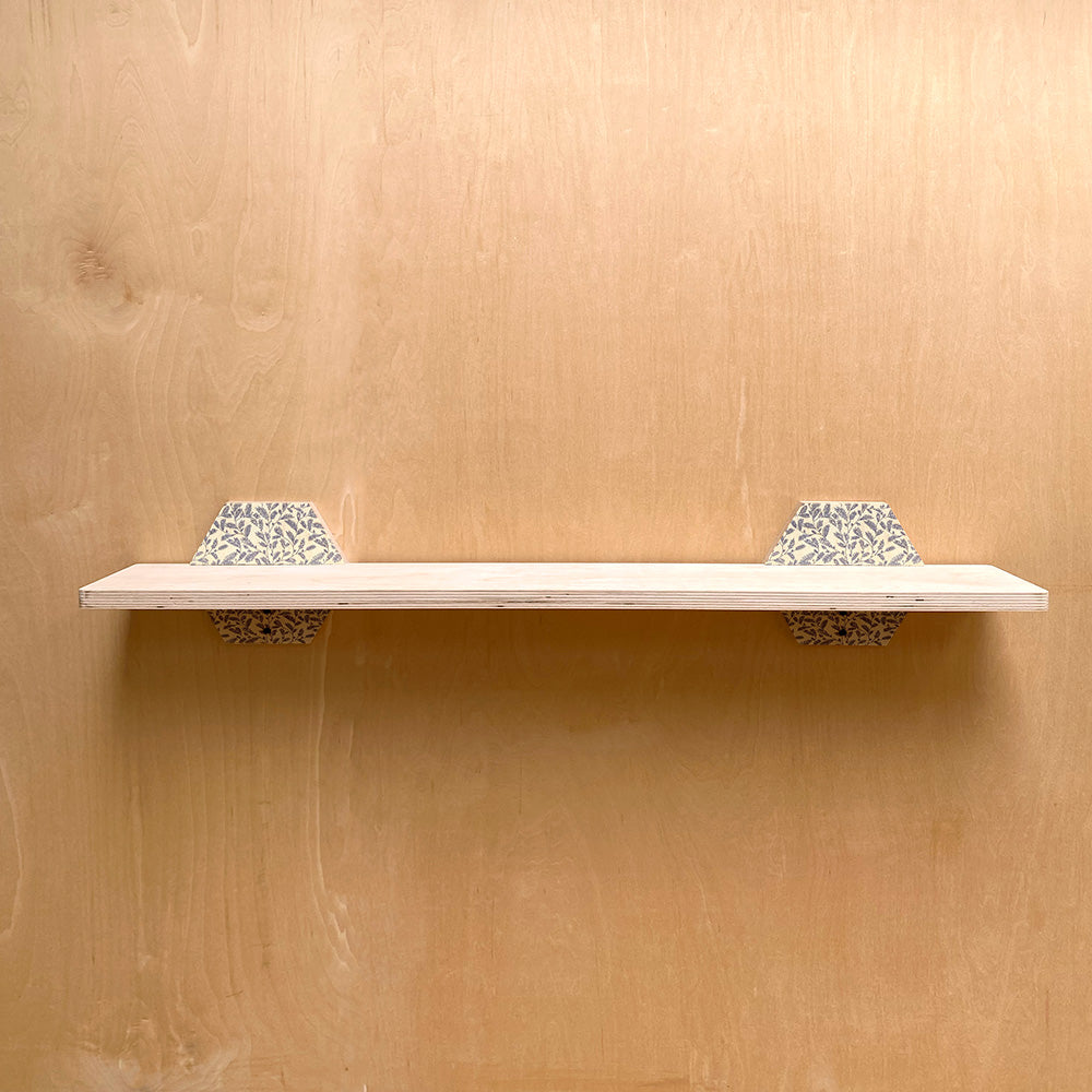 Wooden sturdy wall shelf with patterned brackets for natural charm and durability