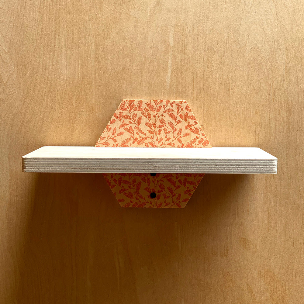 Hexagonal sturdy wall shelf with patterned supports showcasing natural charm for stylish storage