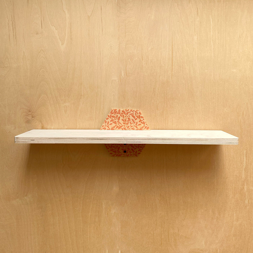 White sturdy wall shelf with patterned support from Simple Sturdy Wall Shelf with Natural Charm