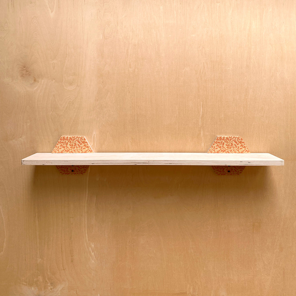 White shelf with patterned supports, showcasing a Simple Sturdy Wall Shelf with Natural Charm