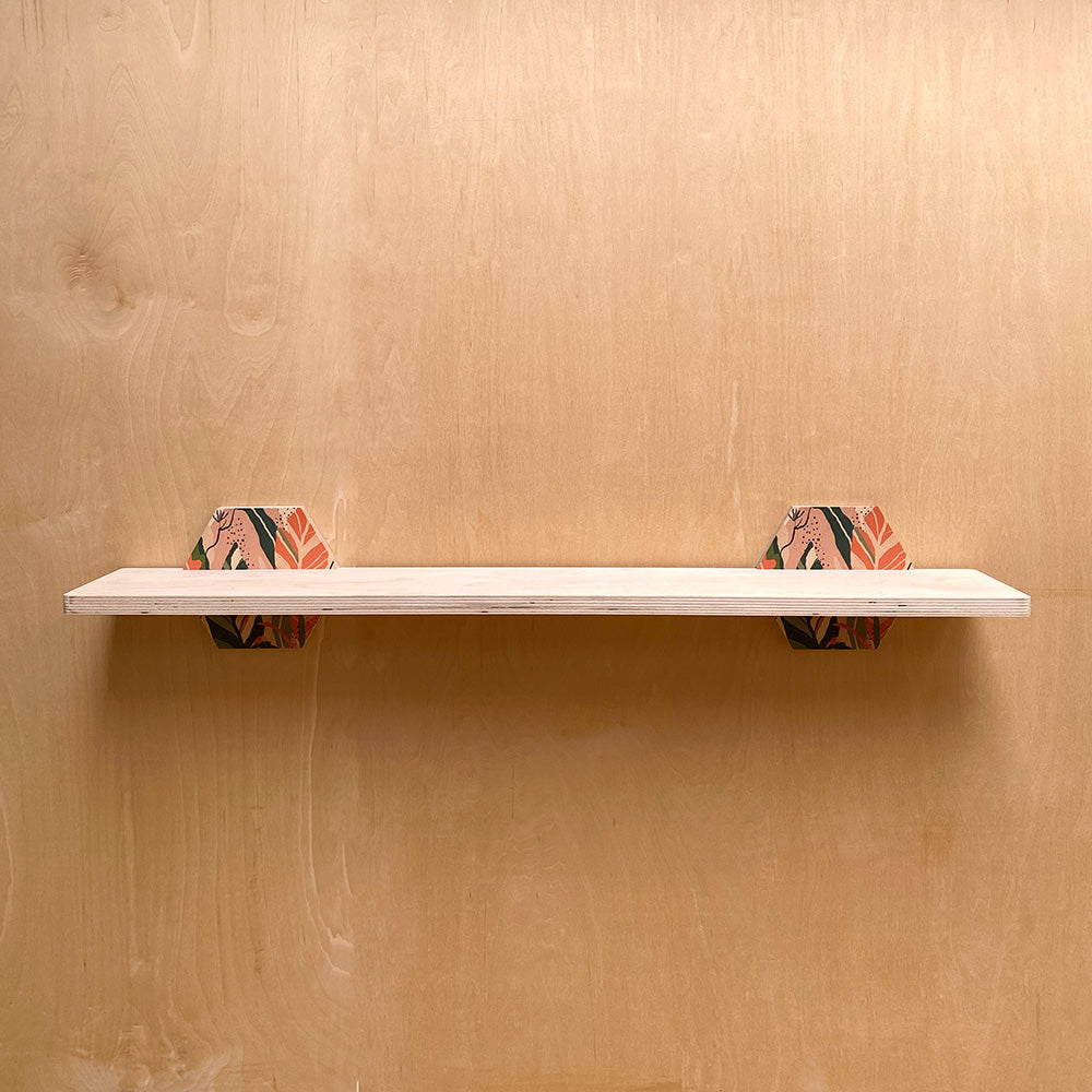 White wall shelf with patterned hexagonal supports for a sturdy wall shelf in nature inspired interiors