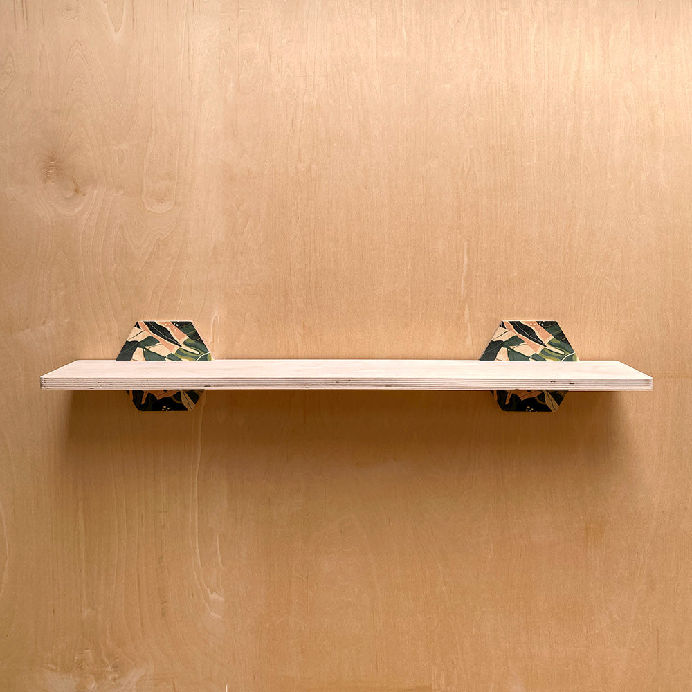White sturdy wall shelf with patterned hexagonal supports for nature-inspired interiors