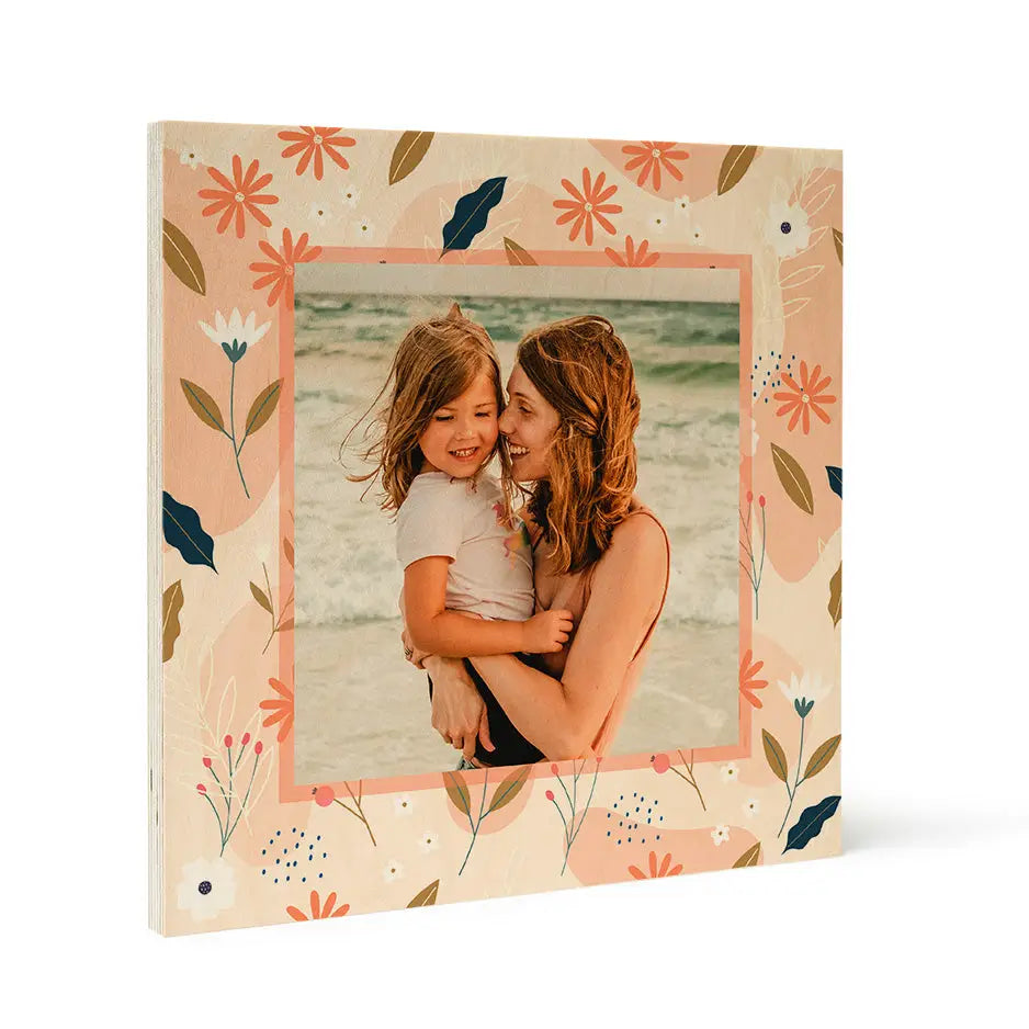 Framed photo locket wood print of a woman and girl on a beach with spring floral border
