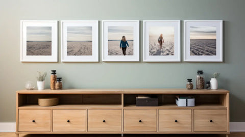 Wooden cabinet with drawers and shelving showcasing framed beach photographs for wood printing.